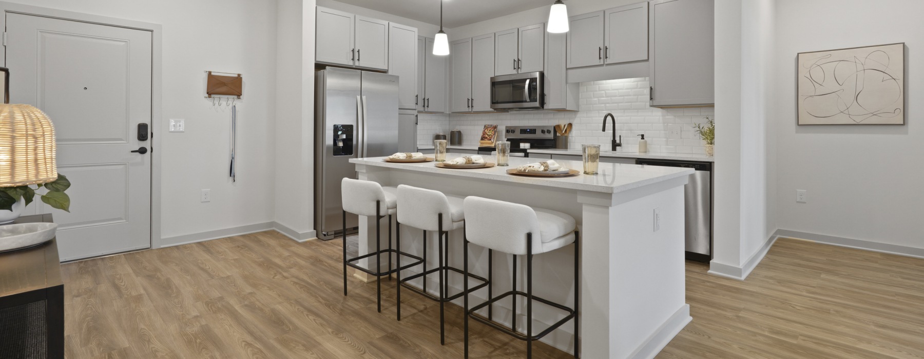 a kitchen with an island and chairs