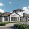 a clubhouse with a driveway and landscaping 
