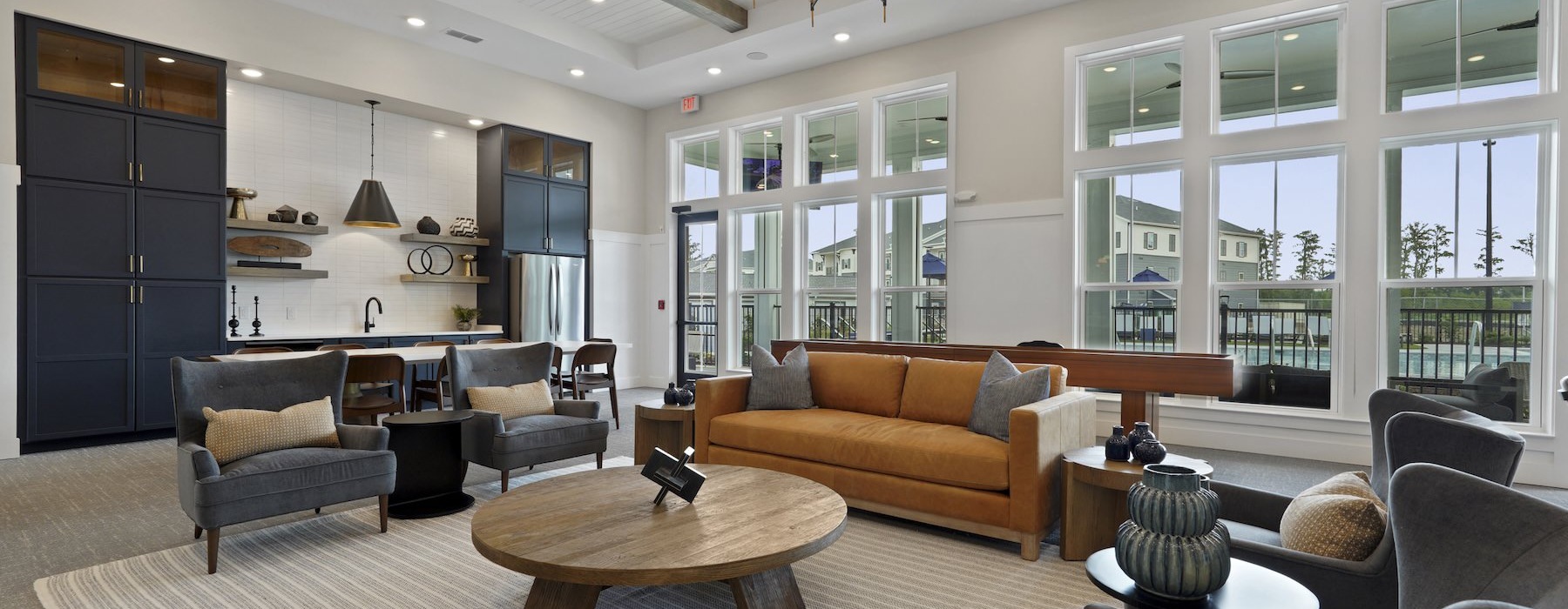 lounge with seating tables chandelier and windows