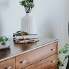 a dresser with plants and books on it